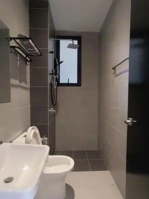 a bathroom with a toilet and a sink and a window at Urban Suites Jelutong Georgetown 2BR Leisure City Night View in Jelutong