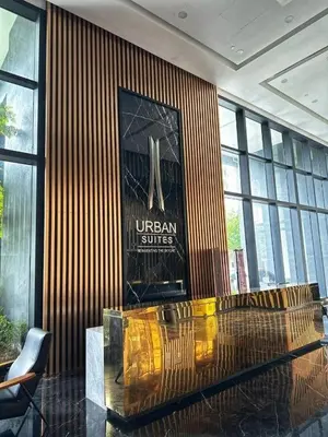 a lobby with a glass table and a sign on the wall at Urban Suites Jelutong Georgetown 2BR Leisure City Night View in Jelutong