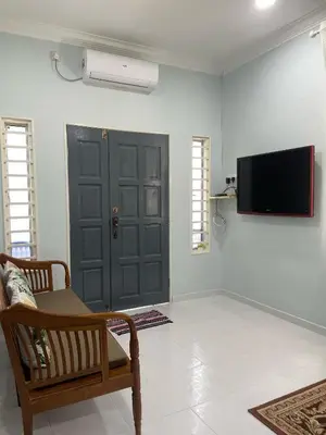 a living room with a black door and a tv at Che Puan Homestay Baling - 2 unit house with kids pool in Baling