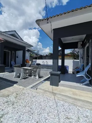 a patio with a table and chairs on a house at Che Puan Homestay Baling - 2 unit house with kids pool in Baling