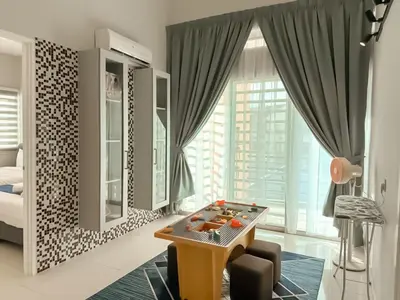 a living room with a table and a bed at Fairy 2 Pool Villa Ipoh 26 Pax Kbox Snooker Lego in Ipoh
