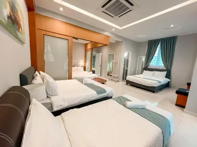 a hotel room with two beds and a couch at Fairy 2 Pool Villa Ipoh 26 Pax Kbox Snooker Lego in Ipoh