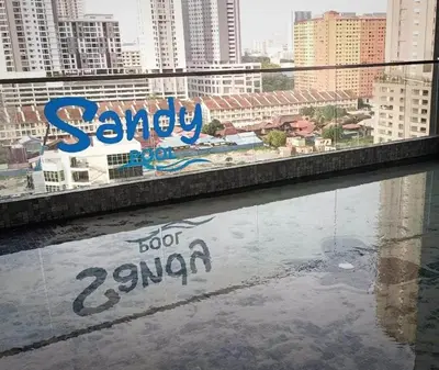 a sign on the side of a balcony with a view of a city at Georgetown Penang - Skyline at Urban Suites - Affordable-Luxury-Cozy Stays with Sea and City Views in Jelutong