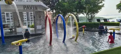 a group of children playing in a water park at Georgetown Penang - Skyline at Urban Suites - Affordable-Luxury-Cozy Stays with Sea and City Views in Jelutong