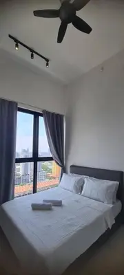 a bedroom with a white bed with a ceiling fan at Georgetown Penang - Skyline at Urban Suites - Affordable-Luxury-Cozy Stays with Sea and City Views in Jelutong