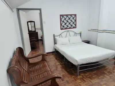 a bedroom with a bed and a chair and a mirror at Cool memories apartment in Tanah Rata