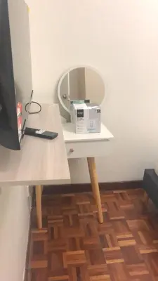 a white table with a mirror and a box on it at Cool memories apartment in Tanah Rata