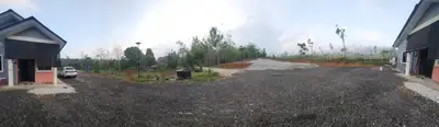 a dirt road next to a house and a car at Homestay Ummi Baling in Baling