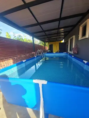 a swimming pool in a house with a blue pool at Homestay Ummi Baling in Baling