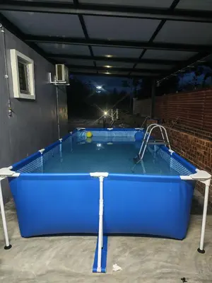 a large blue pool in a garage at night at Homestay Ummi Baling in Baling