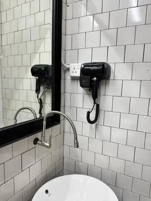 a bathroom with a sink and a mirror at The Harbour by Moonknight in George Town
