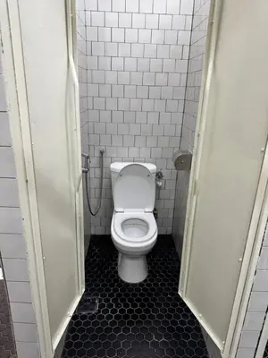 a bathroom with a white toilet in a stall at The Harbour by Moonknight in George Town