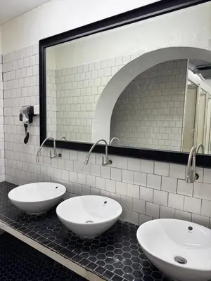 a bathroom with two sinks and a large mirror at The Harbour by Moonknight in George Town