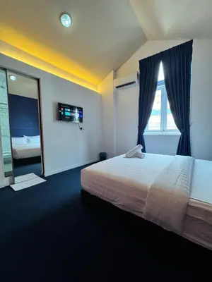 a bedroom with a bed and a large window at The Harbour by Moonknight in George Town