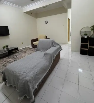 a living room with a bed and a couch at Teratai Bunda Homestay Tambun in Tambun