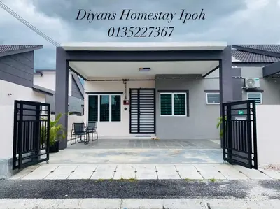 a house with a driveway with a garage at Diyans Homestay Ipoh in Ipoh