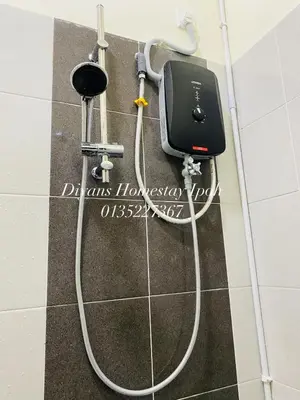 a hose hooked up to a soap dispenser on a wall at Diyans Homestay Ipoh in Ipoh