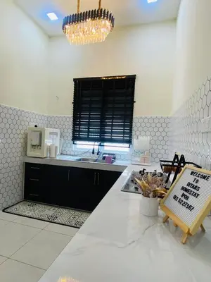 a kitchen with a white counter top and a window at Diyans Homestay Ipoh in Ipoh