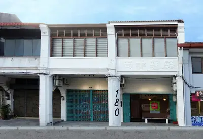 a white building with the number eight on it at A Cozy Place Penang in George Town