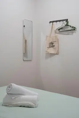 a bathroom with a mirror and towels on a counter at A Cozy Place Penang in George Town