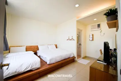 a bedroom with two beds and a television in it at super hotel in Gua Sai