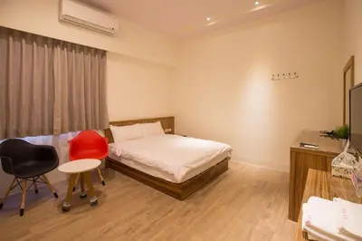 a bedroom with a bed and a desk and a chair at super hotel in Gua Sai