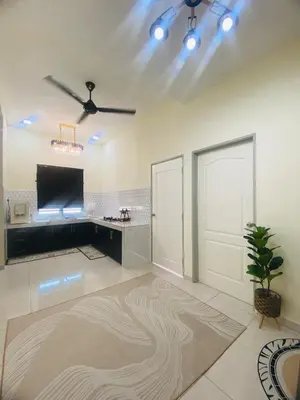 a large living room with a tv and a ceiling at Diyyans Homestay Ipoh in Ipoh