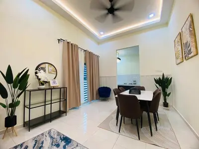 a dining room with a table and chairs and a ceiling at Diyyans Homestay Ipoh in Ipoh
