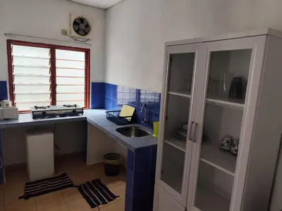 a small kitchen with a sink and a counter at Rainbow Villas in Gua Sai