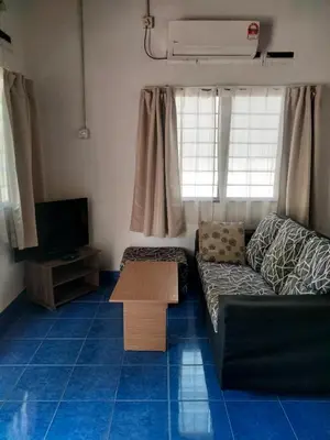 a living room with a couch and a table at Rainbow Villas in Gua Sai