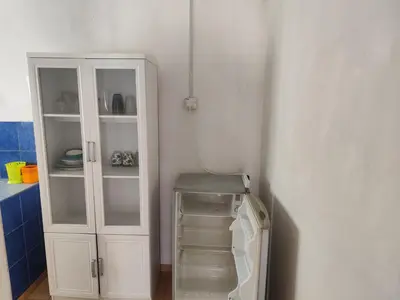 a white cabinet in a kitchen with a refrigerator at Rainbow Villas in Gua Sai