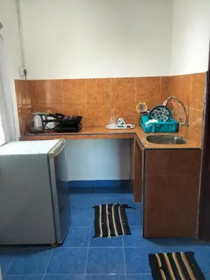 a small kitchen with a sink and a counter at Rainbow Villas in Gua Sai