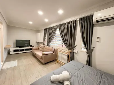 a room with a bed and a couch and a television at Capybara Kids House 12 Pax 5 min to Ipoh Town in Ipoh