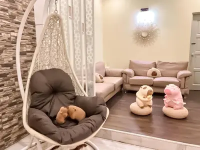 a room with a swing with stuffed animals in it at Capybara Kids House 12 Pax 5 min to Ipoh Town in Ipoh