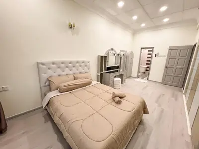 a bedroom with a large bed and a large mirror at Capybara Kids House 12 Pax 5 min to Ipoh Town in Ipoh