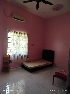 a bedroom with a bed in a room with a window at Homestay Usrati in Taiping