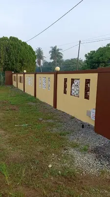 a row of buildings on a field with grass at Homestay Usrati in Taiping