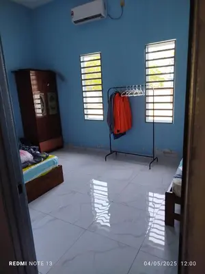 a room with a blue wall and a room with a closet at Homestay Usrati in Taiping