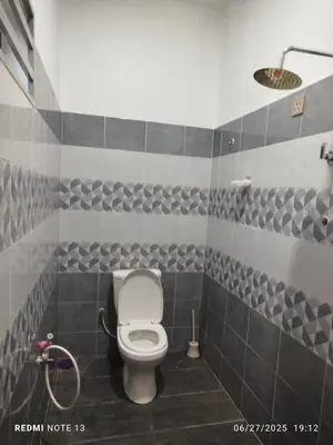 a bathroom with a toilet and a shower at Homestay Usrati in Taiping