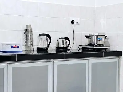 a kitchen with a counter top with a coffee maker at 14\u697c\u53cc\u5c42\u7a7a\u4e2d\u522b\u5885 Double Storey Penthouse Spacious Common Space for Gathering in Sekincan