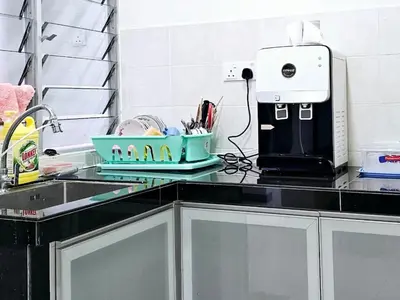 a kitchen counter with a sink and a coffee maker at 14\u697c\u53cc\u5c42\u7a7a\u4e2d\u522b\u5885 Double Storey Penthouse Spacious Common Space for Gathering in Sekincan