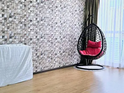 a chair with red pillows sitting in a room at 14\u697c\u53cc\u5c42\u7a7a\u4e2d\u522b\u5885 Double Storey Penthouse Spacious Common Space for Gathering in Sekincan