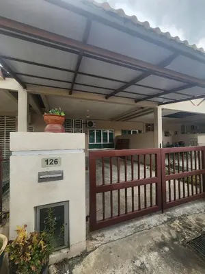 a house with a fireplace in front of a fence at Dirgahayu Homestay II Nuri in Kulim
