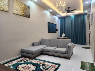 a living room with a couch and a ceiling fan at Dirgahayu Homestay II Nuri in Kulim