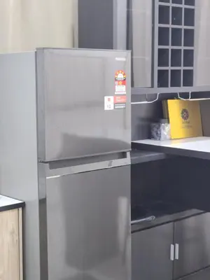 a stainless steel refrigerator in a kitchen at Dirgahayu Homestay III Serindit in Kulim