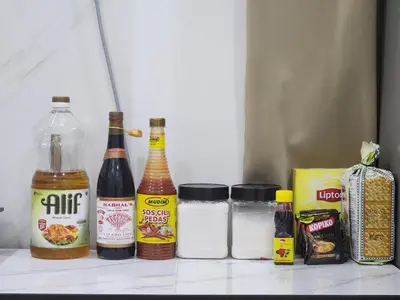 a refrigerator with bottles of alcohol and other food items at Dirgahayu Homestay III Serindit in Kulim