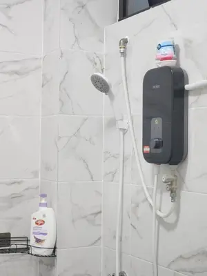 a bathroom with a soap dispenser on a wall at Dirgahayu Homestay III Serindit in Kulim