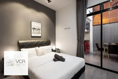 a bedroom with a white bed and a dining room at Yenny Cottage - Canning Private House Spacious in Ipoh
