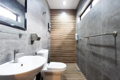 a bathroom with a white toilet and a sink at Yenny Cottage - Canning Private House Spacious in Ipoh