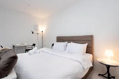 a bedroom with a large white bed and a desk at Casa Bella - Private Studio Ipoh - Pet allowed in Ipoh